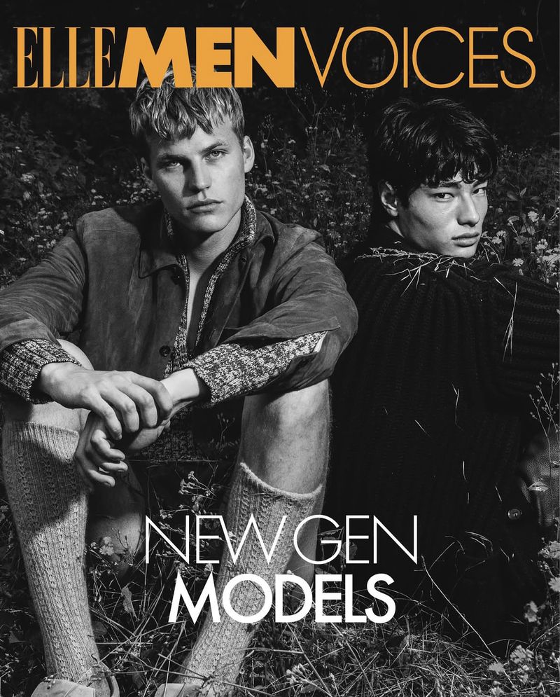 Magazine cover featuring two male models in outdoor setting. Men wear textured shirts and socks; ELLE MEN VOICES and NEW GEN MODELS text overlay.