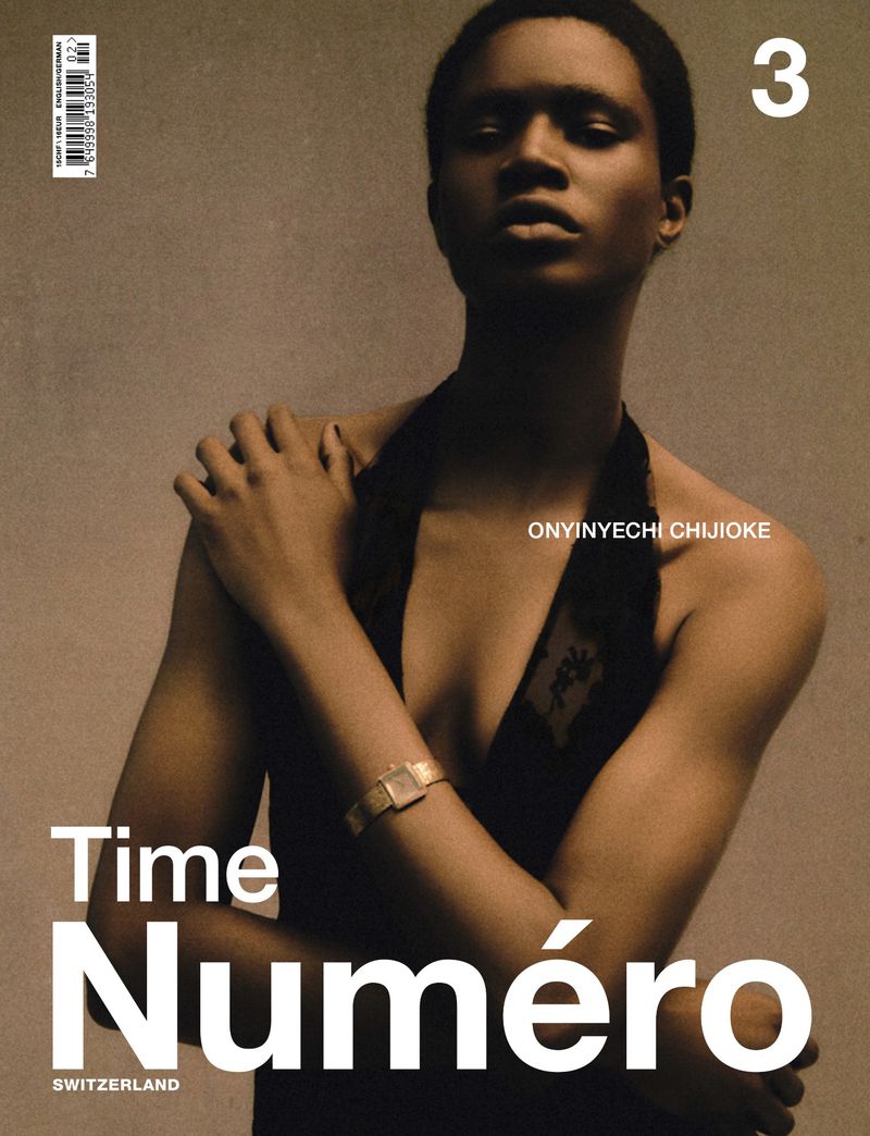 Magazine cover featuring a Black woman wearing a sleeveless dress, posed in front of a neutral backdrop, highlighting fashion and portraiture.