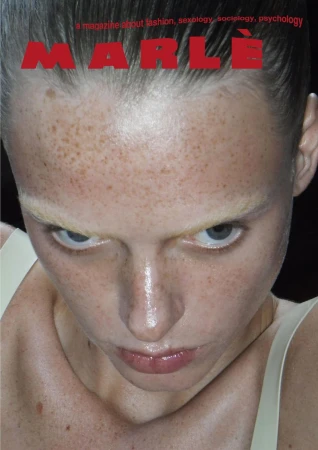 Close-up portrait of a fair-skinned adult female with freckles and pale blonde hair, featured on the cover of MARLE magazine.