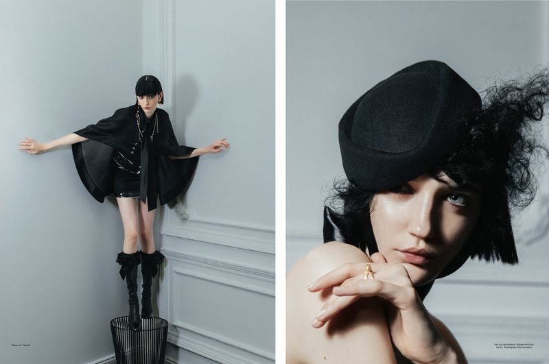 Editorial fashion shot of a woman in black hat and clothing, posed indoors with hands out, and a close-up headshot on the right side.