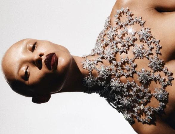 Model Georgia Palmer wearing an intricate floral crystal chest piece against a white backdrop for Swarovski: Wonder World.