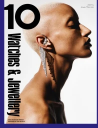 Model Georgia Palmer in profile with bleached buzz cut wearing a crystal fringe ear cuff against a white studio background.