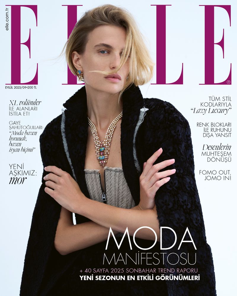 Elle magazine cover featuring a fair-skinned model with blonde hair wearing a coat, bustier top, and necklace, against a neutral background.