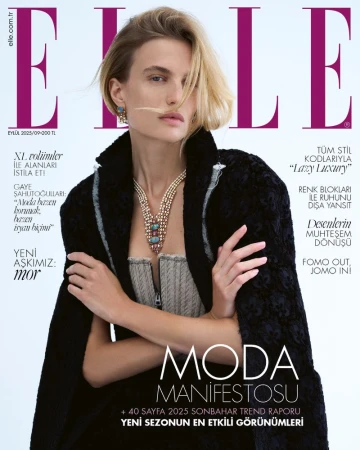 Elle magazine cover featuring a fair-skinned model with blonde hair wearing a coat, bustier top, and necklace, against a neutral background.