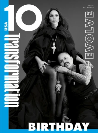 Magazine cover featuring a woman in a black robe and a man with tattoos, set against a gray background with blue and white text.