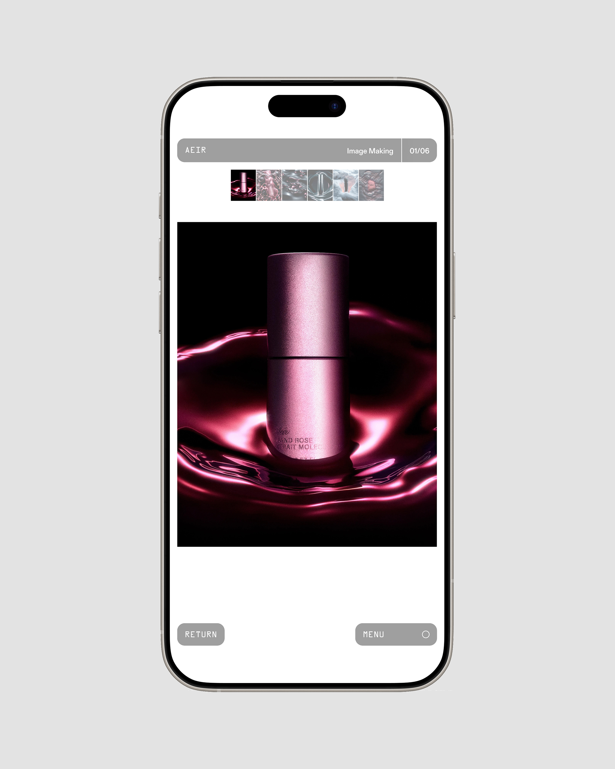 Image on a smartphone screen shows a pink cosmetic product with light reflecting off a dark fluid-like surface, beauty shot.