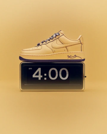 Tan Nike Air Force 1 sneaker with purple accents atop a retro digital clock displaying 4:00 AM, set against a tan backdrop.