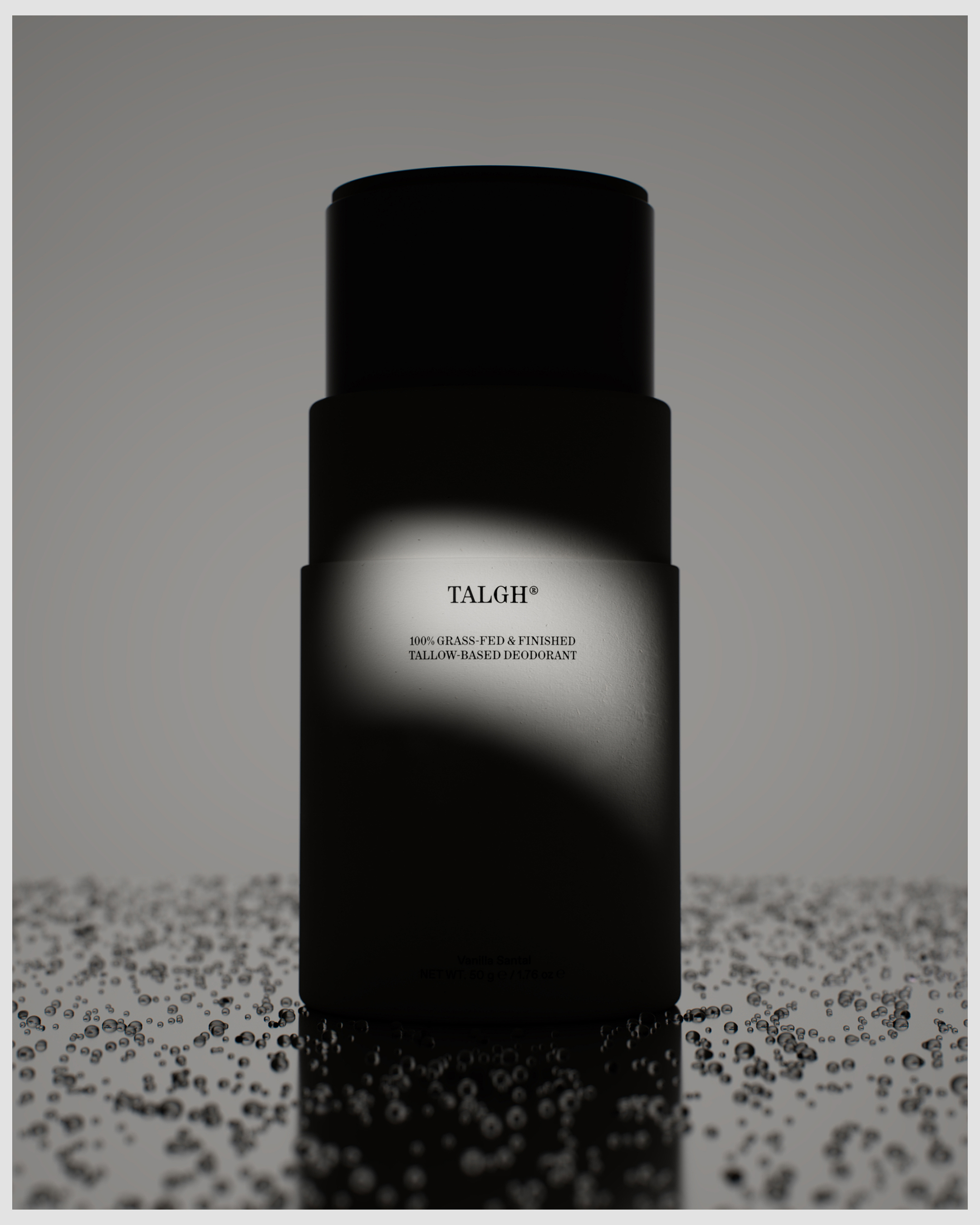 Minimalist studio shot of black deodorant stick with product details against a neutral background with water droplet effect.