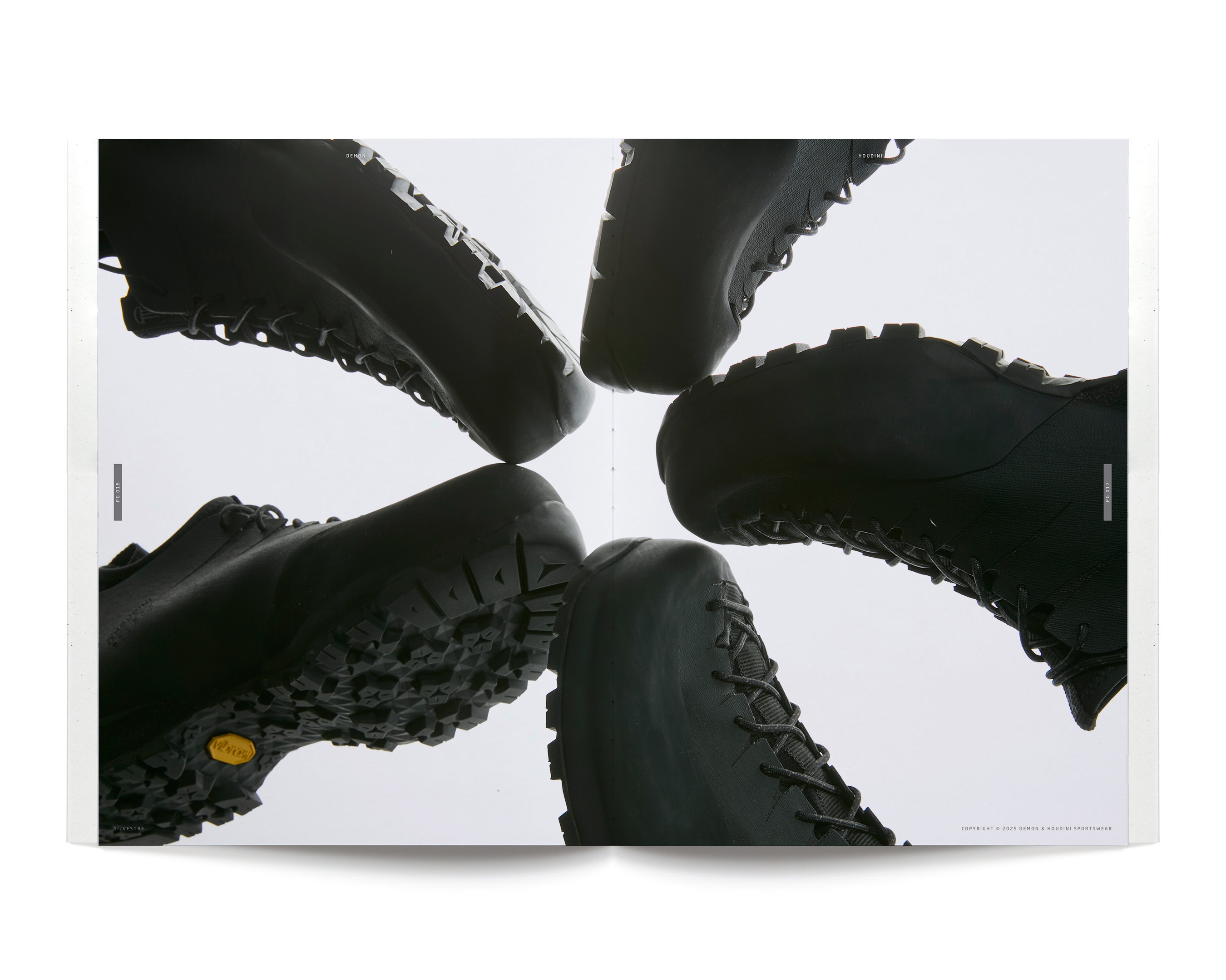 Overhead shot of a star-shaped arrangement of black leather hiking boots on a white surface showcasing the soles and lug patterns.