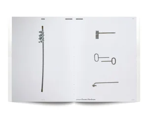 Magazine spread displaying climbing hardware and a steel cable with clamps arranged across white pages.