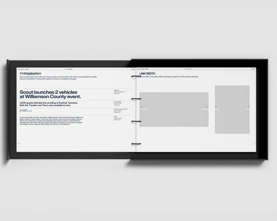 Open book or magazine displaying typography and layout design concepts on white pages with a black spine, showcasing creative design.
