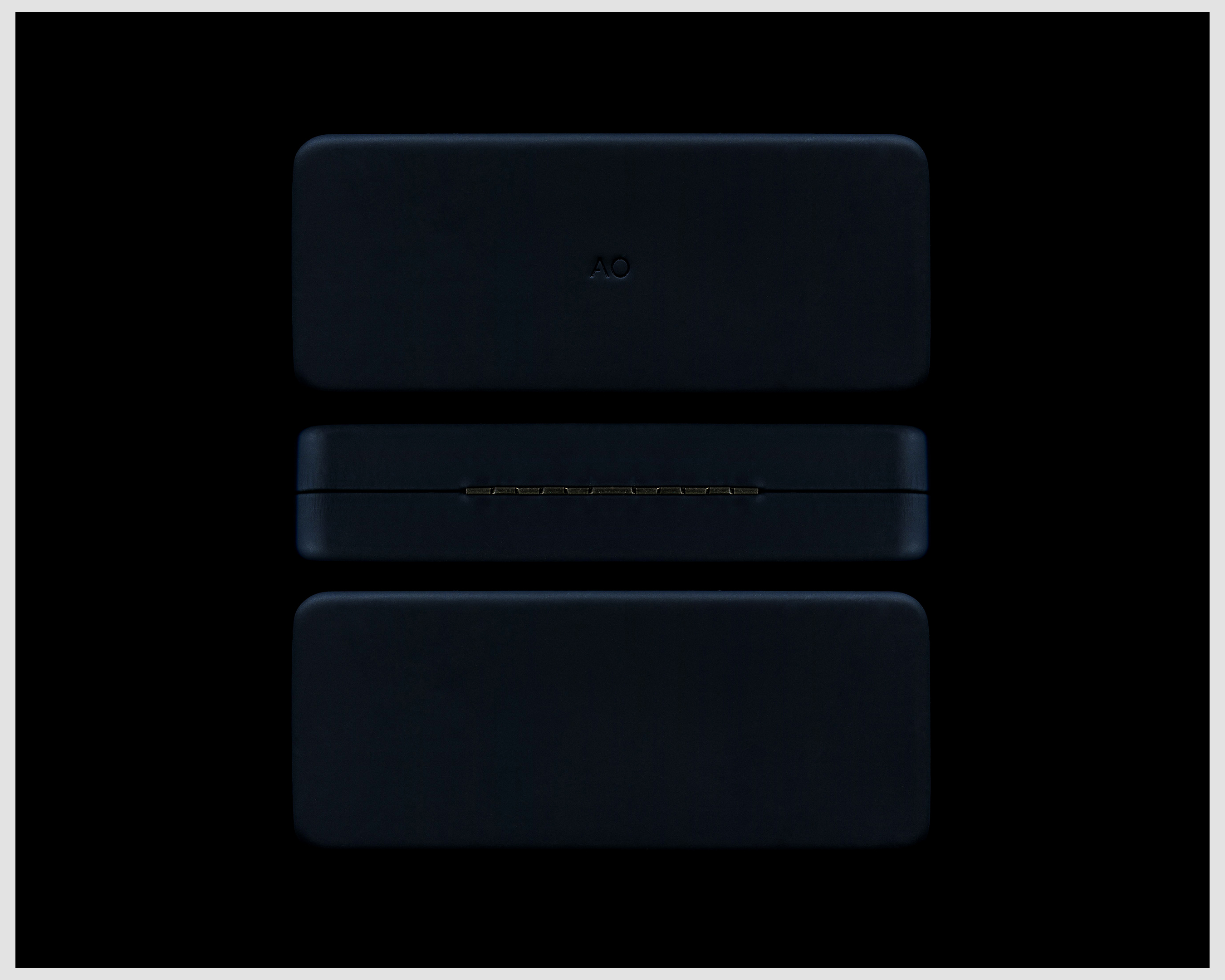 Three dark blue cases stacked vertically against a black background. The middle case is positioned to show a hinge detail.