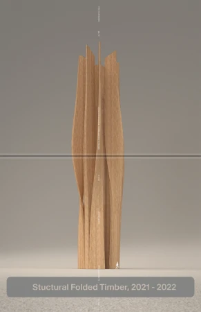 Tall, abstract sculpture with vertical wood strips, creating an organic, botanical form, softly lit on a neutral gray background.