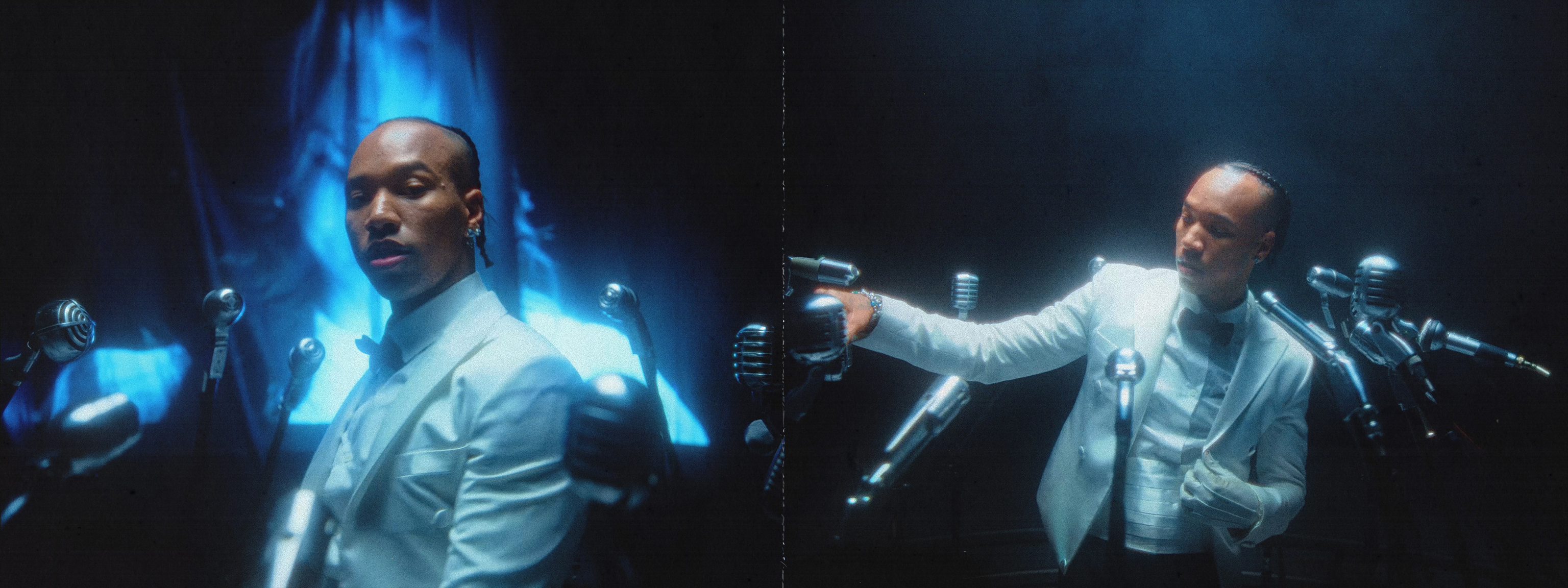 An African American man in a white tuxedo stands in front of vintage microphones, creating a classic performance atmosphere.