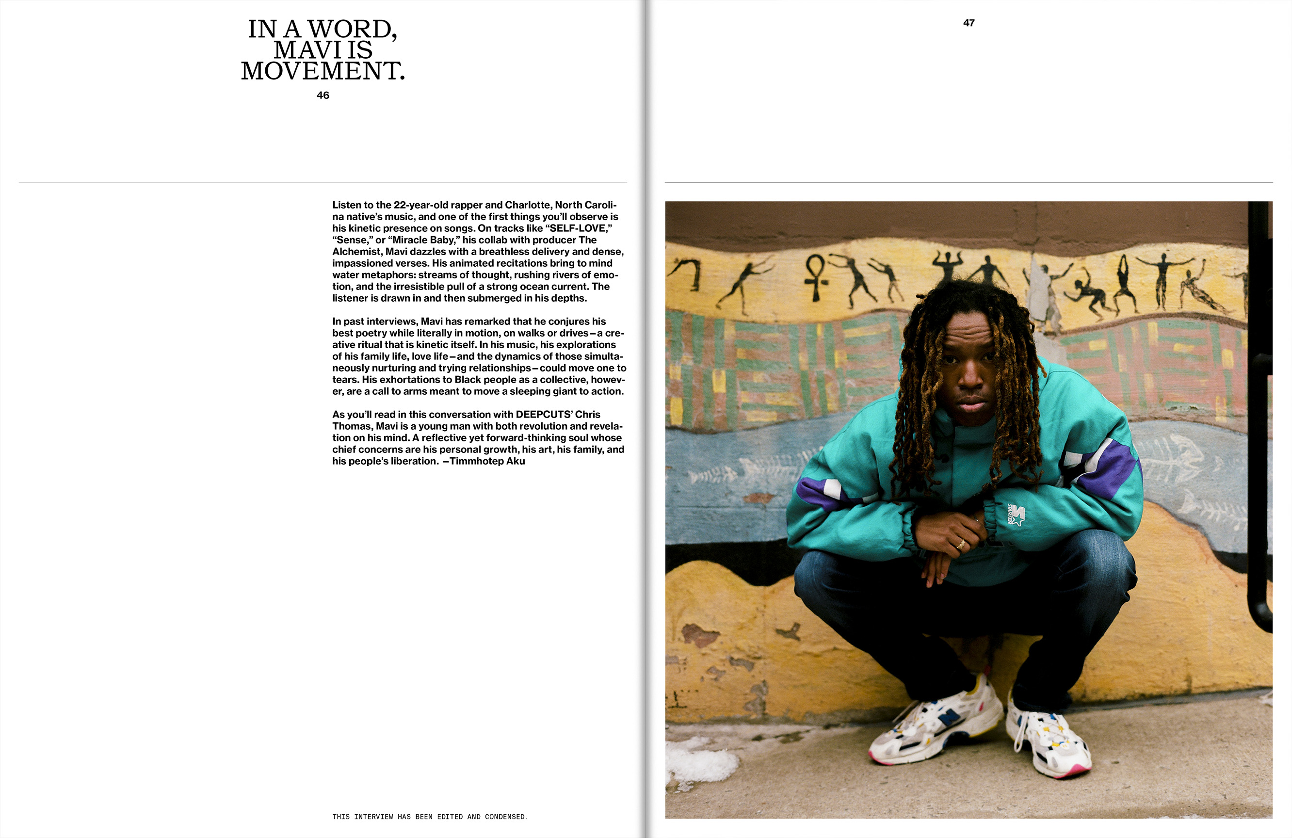 A young black male rapper, Mavi, in teal jacket, jeans, and sneakers, squats in front of a wall mural in an outdoor urban setting.