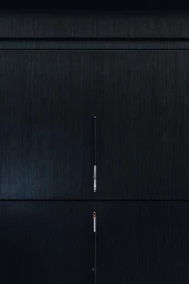 Close-up of minimalist dark brushed wood cabinetry featuring slim vertical metallic pull handles and horizontal panel seams.