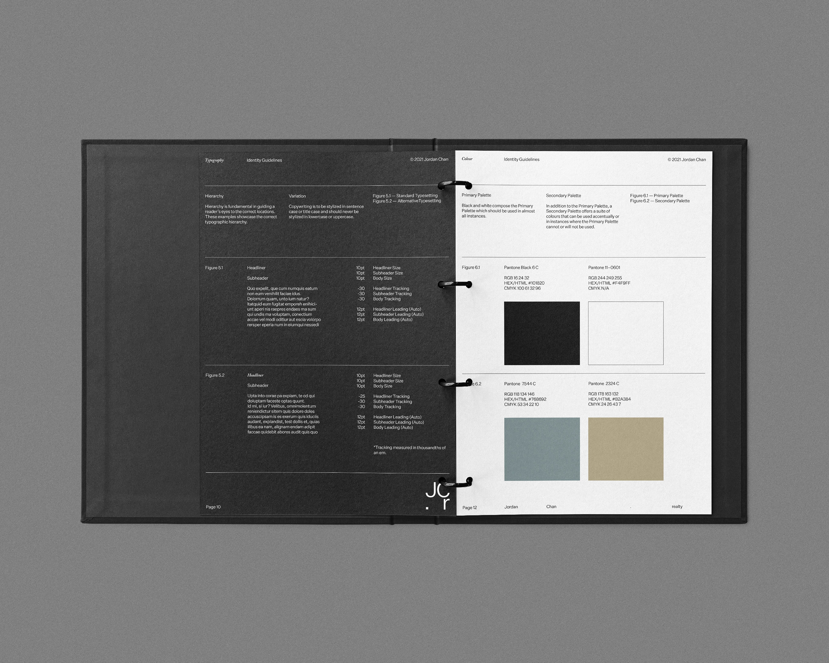 Open black ring binder displays printed pages with colour swatches and technical information. The pages show Pantone colour palettes.