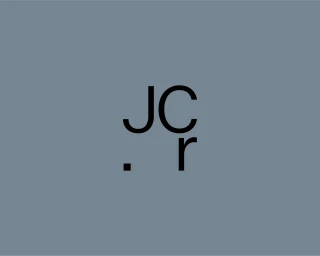 Black minimalist monogram logo featuring letters JC and r on a solid slate blue background.
