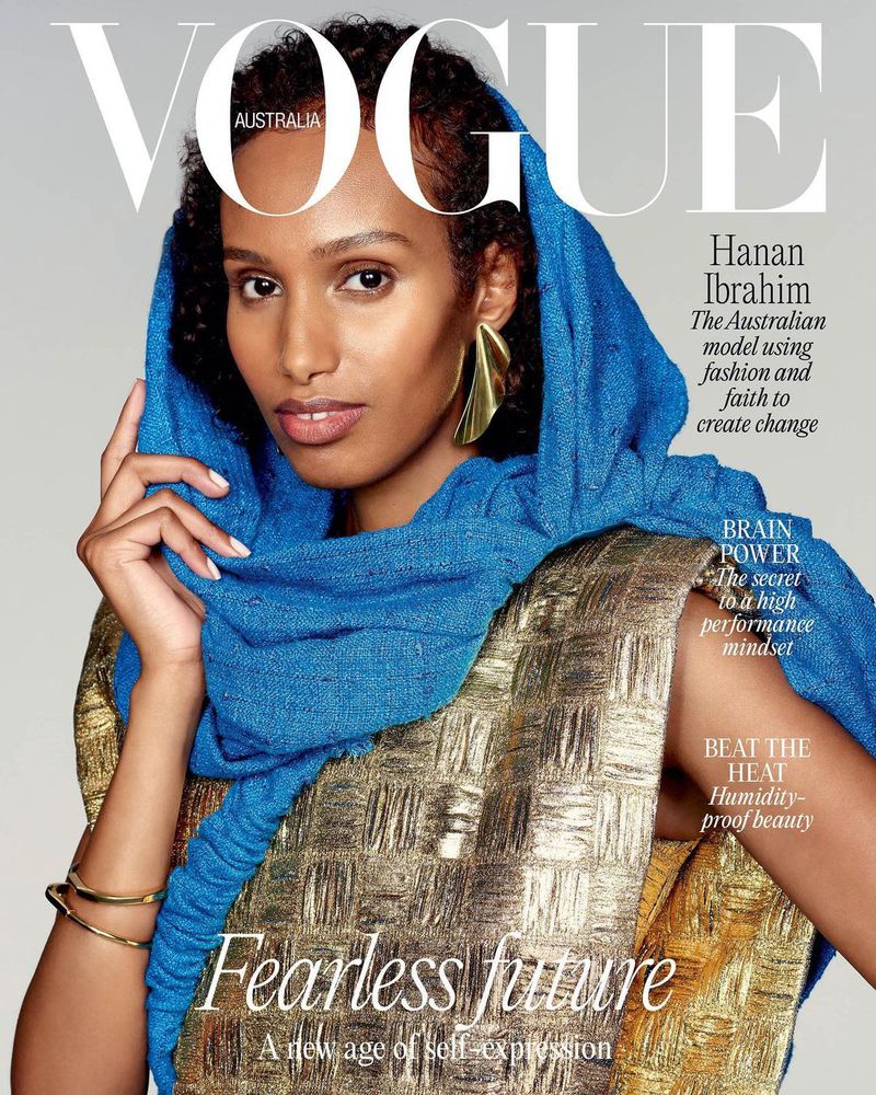 Model Hanan Ibrahim wearing a blue headscarf and gold textured top against a neutral background for Vogue Australia