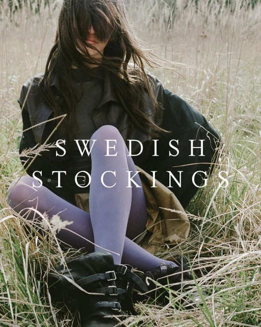 Woman in grassy field wears stylish stockings with black boots, showcasing a blend of fashion and nature in an outdoor setting.