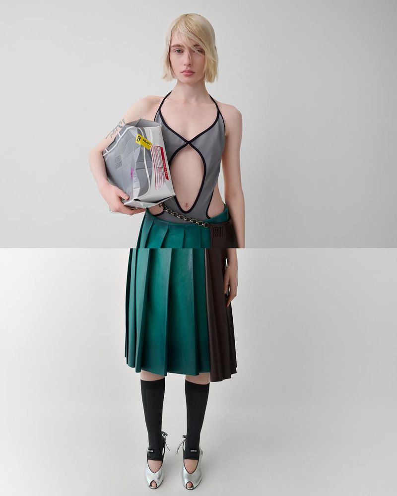 Fashion photography features a woman in a gray and teal outfit with knee-high socks and silver heels against a pale gray background.