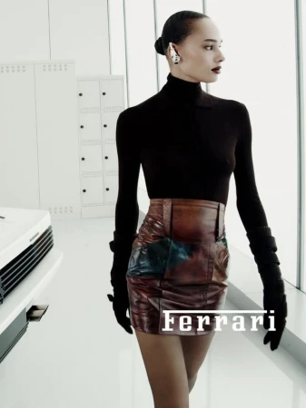 Fashion shoot of a stylish woman in a black top and patchwork skirt in a modern white space with geometric lockers and windows.