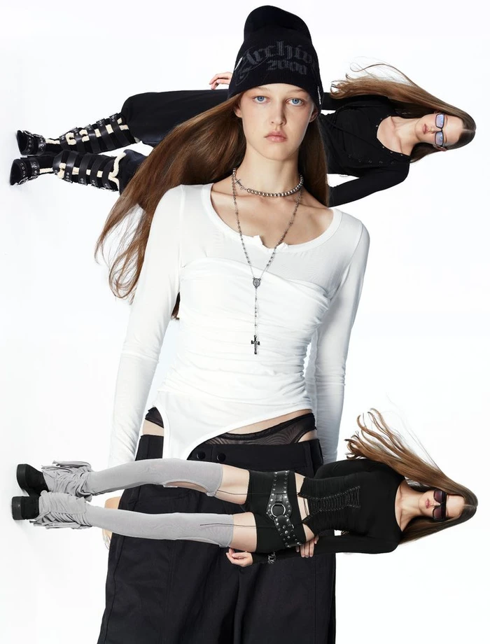 Multiple layered images of female models wearing black beanies, white tops, and black trousers against a white background.