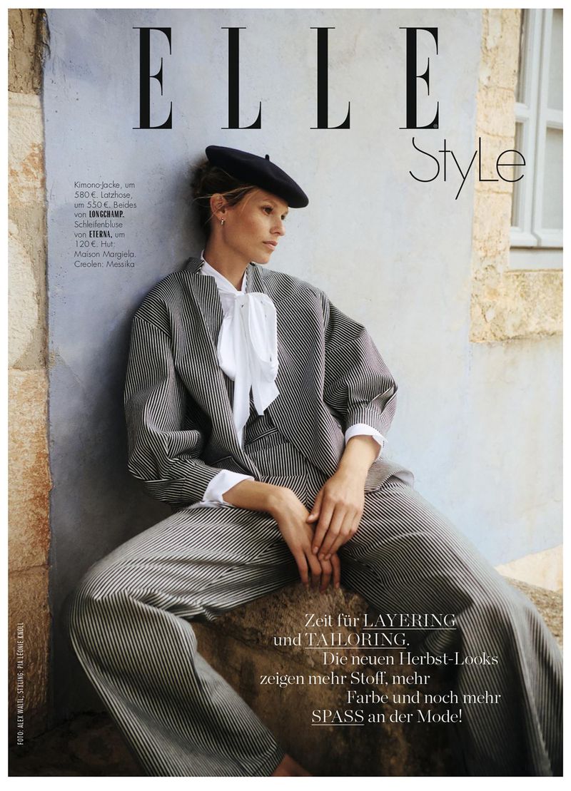 Elle Style magazine cover featuring a woman in a striped suit and beret, seated against a textured wall with natural light.