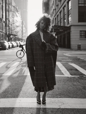 Model Aliza Jarmon wearing a plaid coat on a city street for M Revista de Milenio