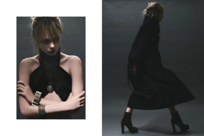 Fashion editorial photo: a woman in a black wraparound top and bracelets plus another woman in a long black coat and platform boots.