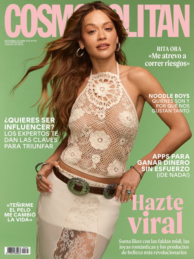 Cosmopolitan magazine cover featuring Rita Ora in a crocheted halter top and skirt on a light green background with pink text.