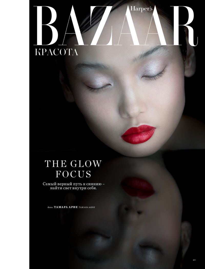 Close-up beauty shot features an Asian female model with closed eyes, red lipstick, a reflection, and Bazaar Harper's magazine cover text.