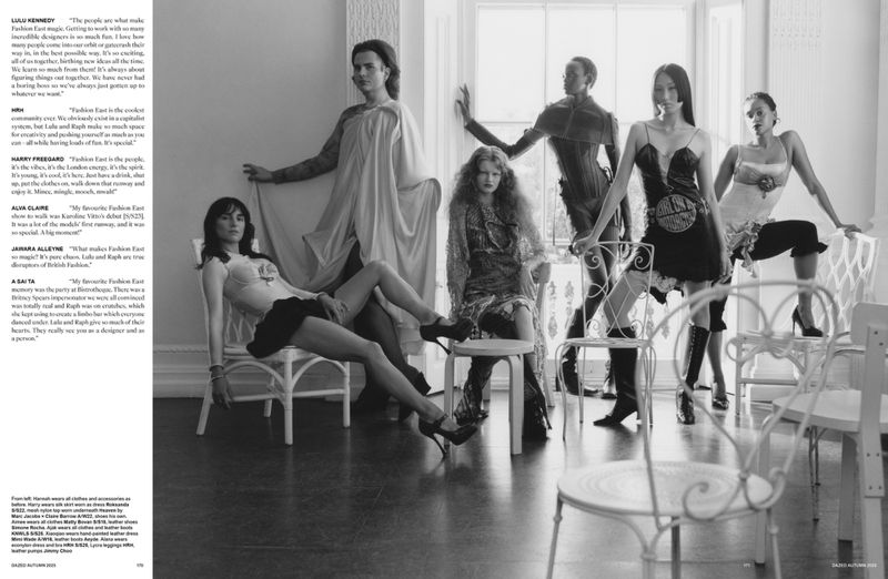 Editorial fashion shot featuring five models in clothing, posed in a room with chairs and window light, black and white.