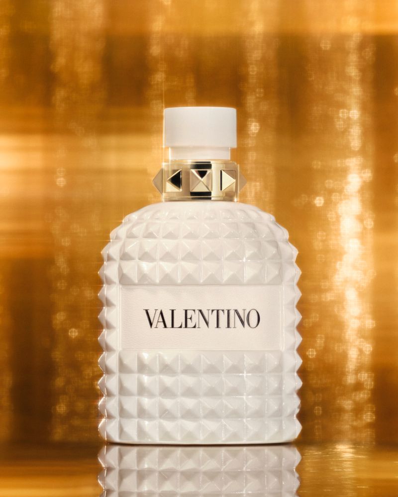 Close-up studio shot of Valentino perfume bottle against a shimmering gold background, capturing luxury and modern beauty.