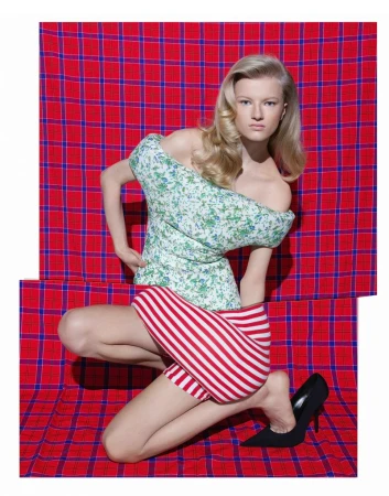 An adult female model poses in a photo studio wearing a blue jacket and matching skirt with text on a blue background.