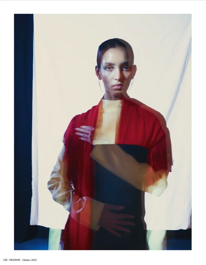 Model with multiple exposure effect wearing a red fringed wrap over dark clothing against a light backdrop for Madame Germany editorial