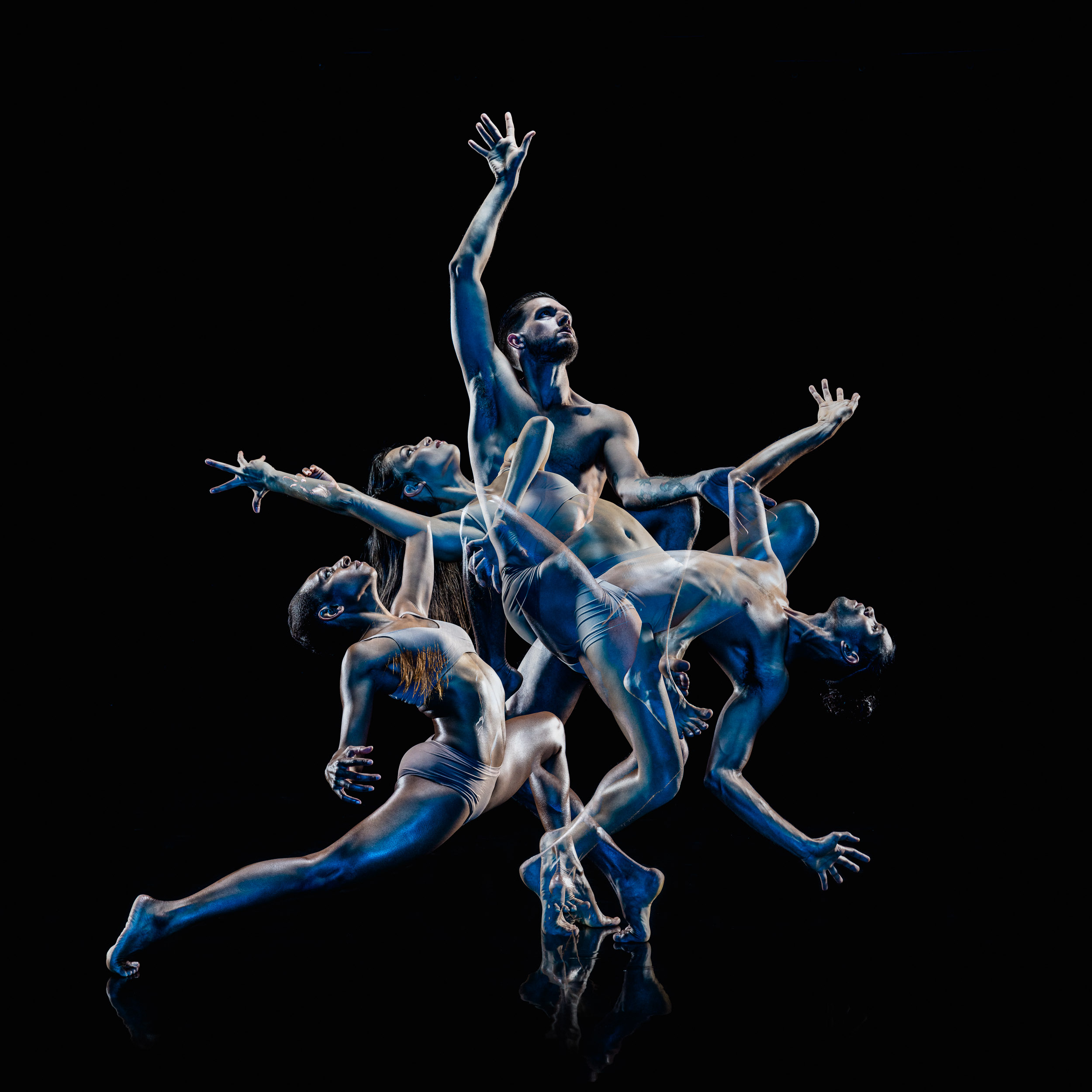 Multi-exposure shot of a male and female dancer in motion against a black background. Dynamic poses create an abstract, rhythmic pattern.