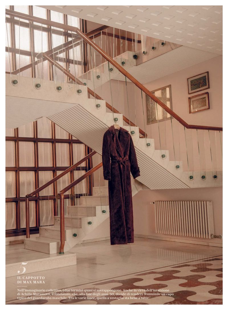 Long brown coat on stairway with patterned floor, creating an elegant fashion editorial for interior design and style inspiration.