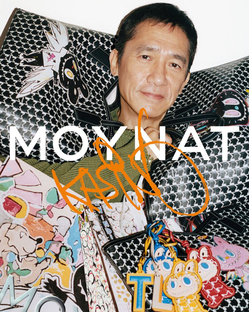 Headshot of Asian man surrounded by colorful designer handbags. The image features product branding, artistic details, and studio lighting.
