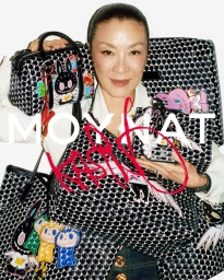 Michelle Yeoh holding patterned luxury handbags and luggage for Moynat campaign