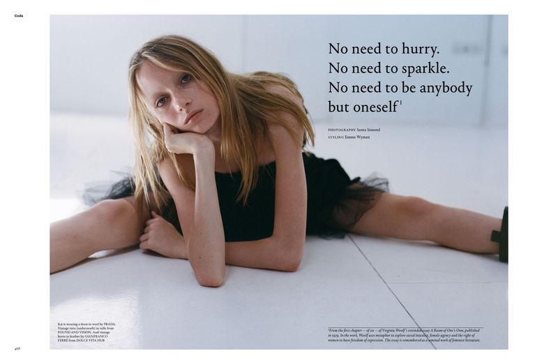 A young woman in a black dress reclines on a white floor, leaning on her arm with text overlayed on the right side of the frame.