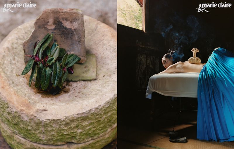 Stone vessel with plant next to woman receiving spa treatment featuring a cloth poultice on her back inside a dark, wood-paneled room.