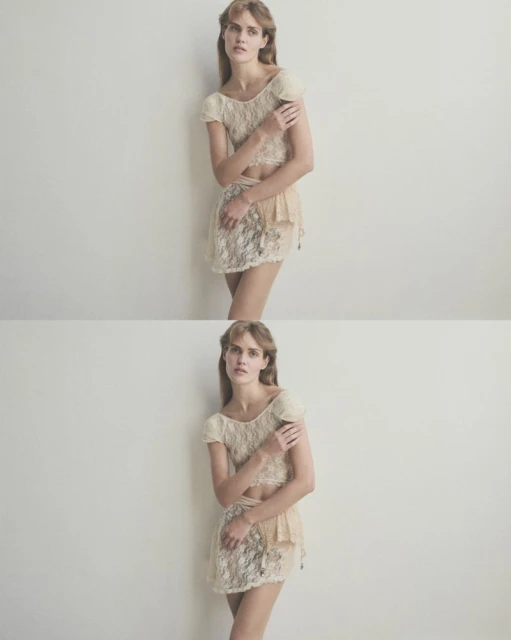 Woman in lace top and skirt posing against a white wall in a fashion studio; soft, diffused lighting enhances the delicate texture.