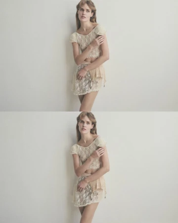 Woman in lace top and skirt posing against a white wall in a fashion studio; soft, diffused lighting enhances the delicate texture.