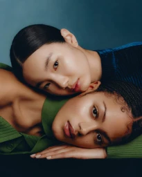Close-up portrait of two women resting their heads together in a studio setting by photographer Tobias Delcroix