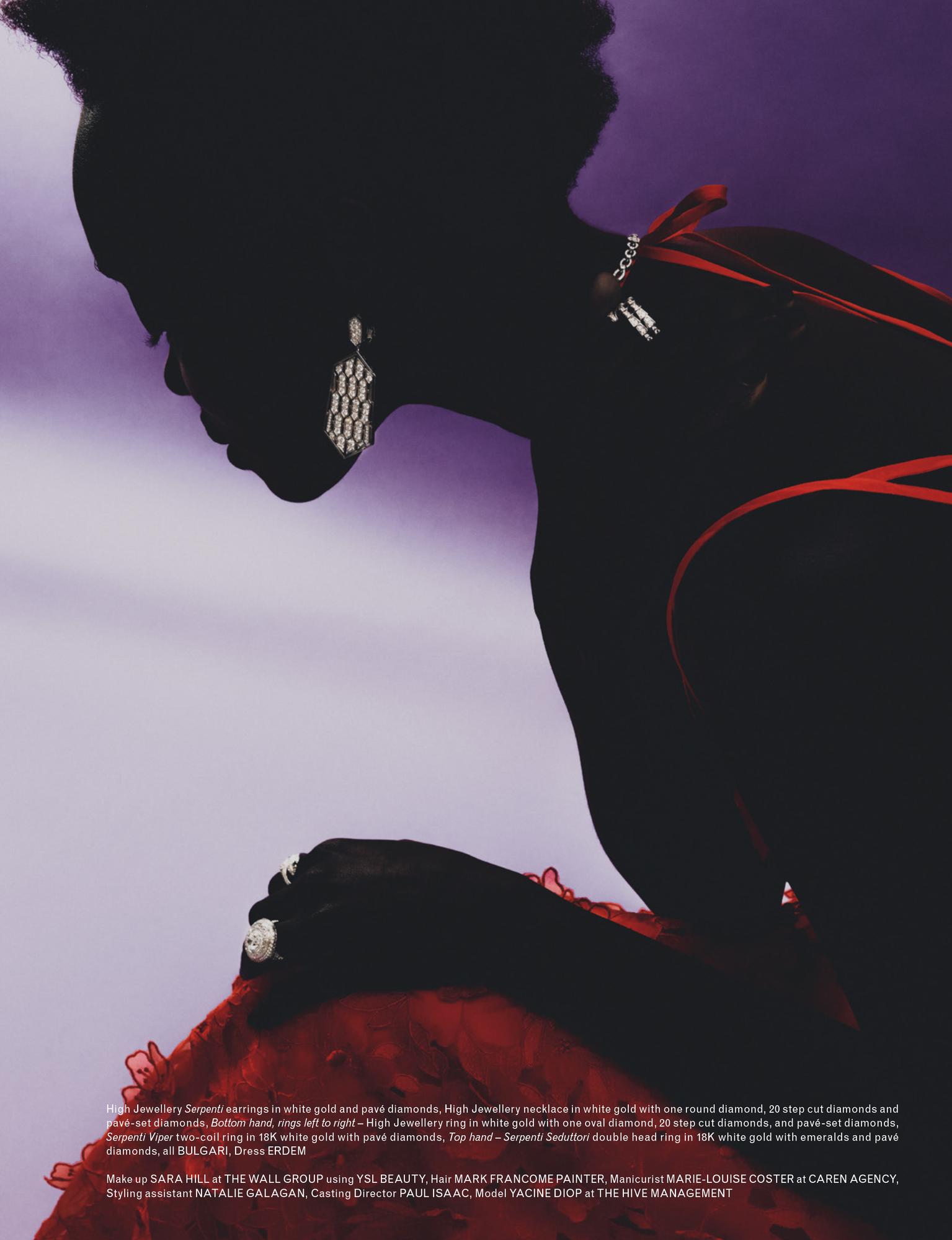 Fashion shot features a dark-skinned woman in a red dress and jewelry, silhouetted against a purple background. Close-up on model's face and hands.