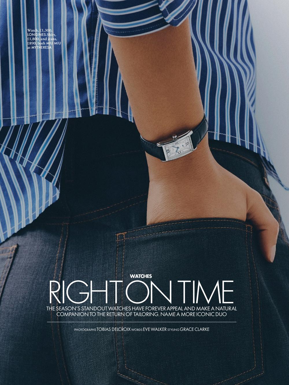 Close-up shot of an arm with a wristwatch, denim jeans pocket visible, and a blue striped shirt, against a neutral background.
