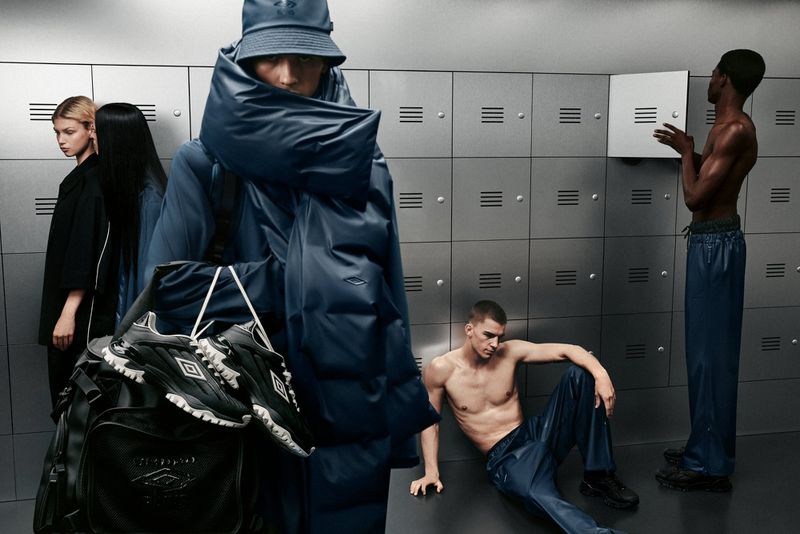 Several people pose in a locker room setting, wearing athletic apparel and carrying a duffel bag with shoes, showcasing an athleisure fashion style.