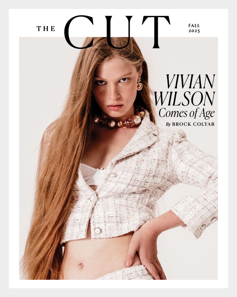 Magazine cover featuring a young fair-skinned woman with long strawberry blonde hair wearing a tweed jacket, large earrings, and a beaded necklace.