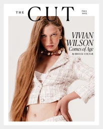 Vivian Wilson posing for The Cut magazine cover wearing a cropped tweed jacket and statement necklace against an off-white background.
